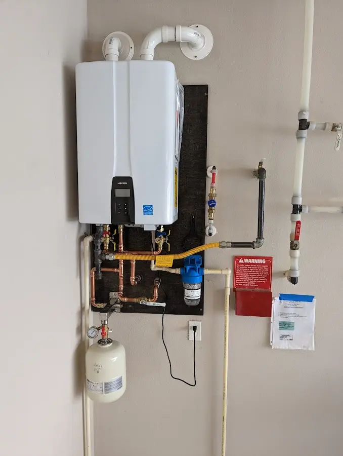 Professional plumber installing copper piping in a Oxford home